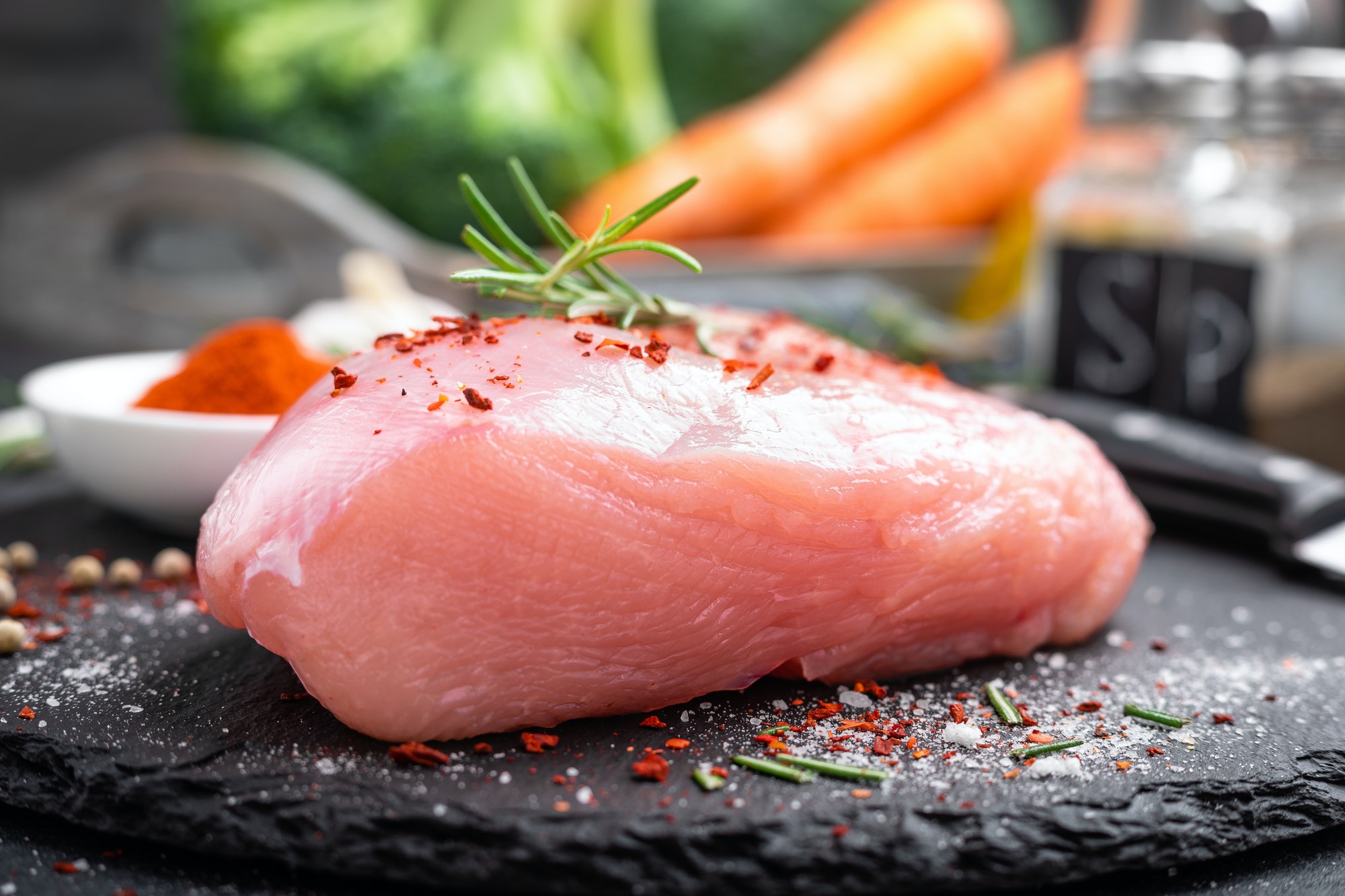 Fresh raw turkey meat fillet with ingredients for cooking